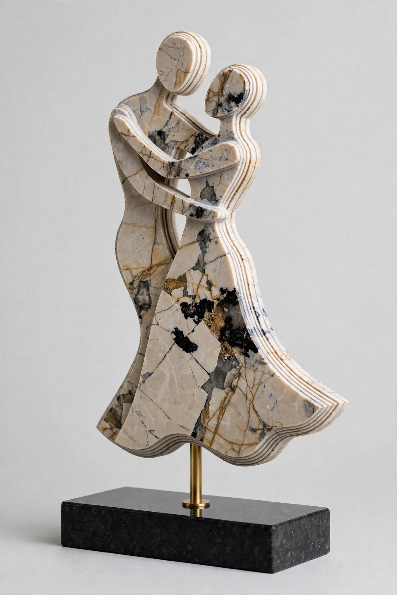 First Waltz — a layered breccia marble silhouette of two dancers embracing, mounted on a brass rod above a black granite base.