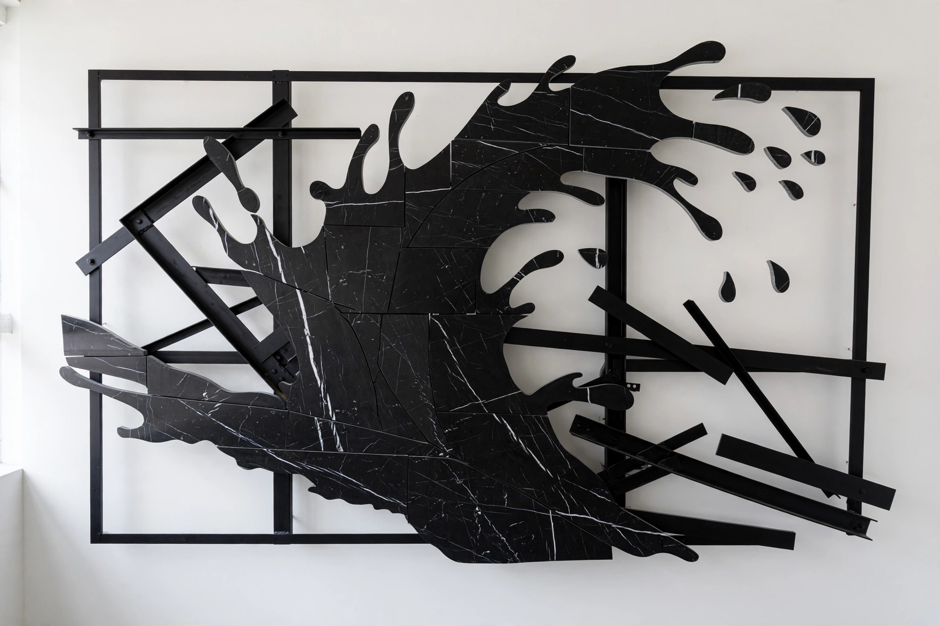 Nero Wave — a black marble splash with white veining on a black steel grid.
