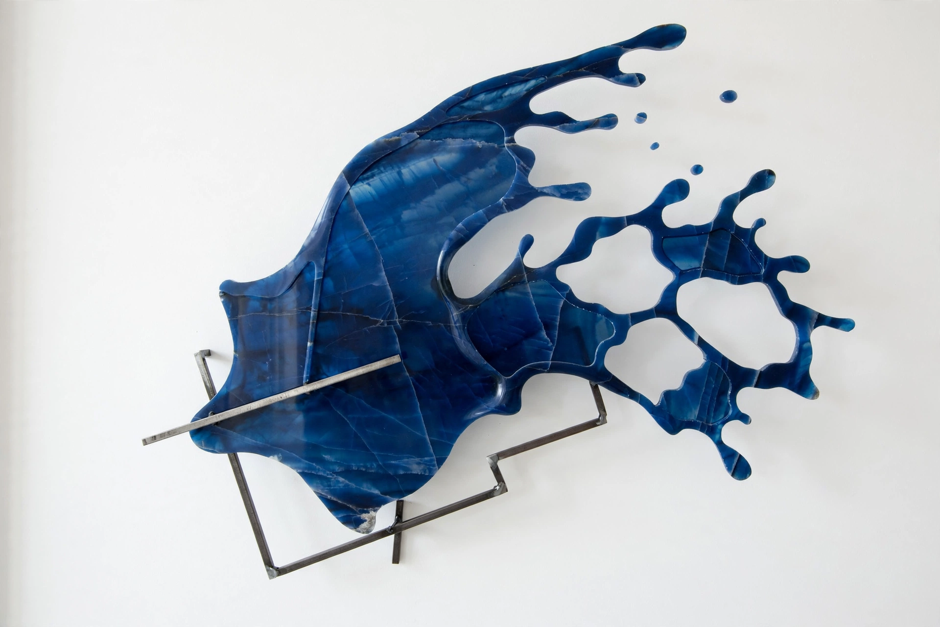 Undertow — a deep blue onyx splash pierced by a single steel bar.